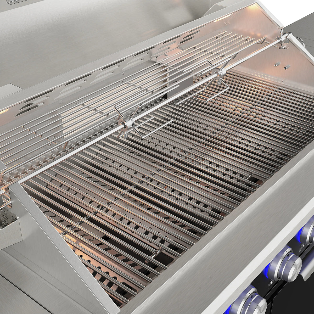 Close-up of metal cooking grates inside open grill with lit burners