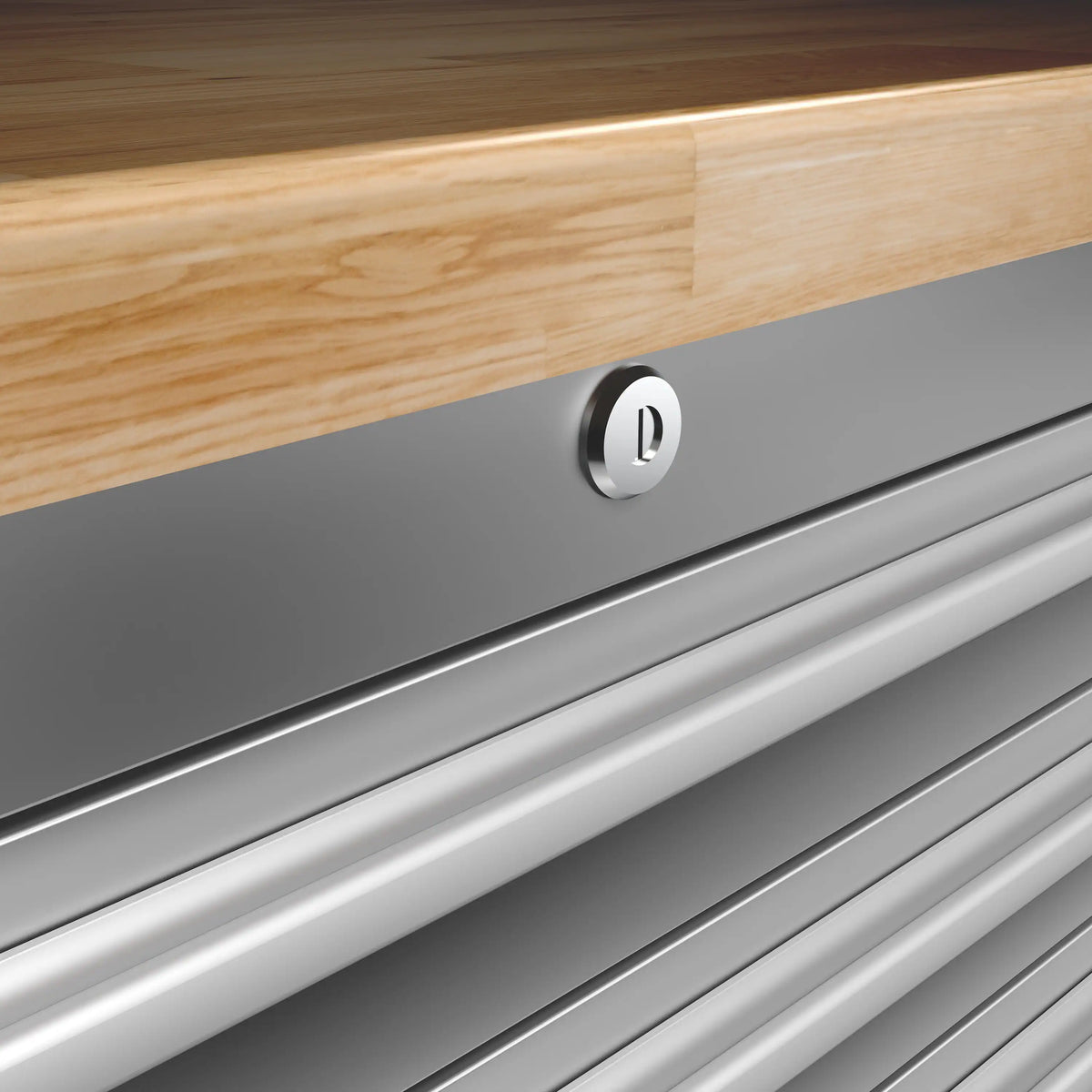 Tool workbench drawer front with round chrome handle under light wood countertop