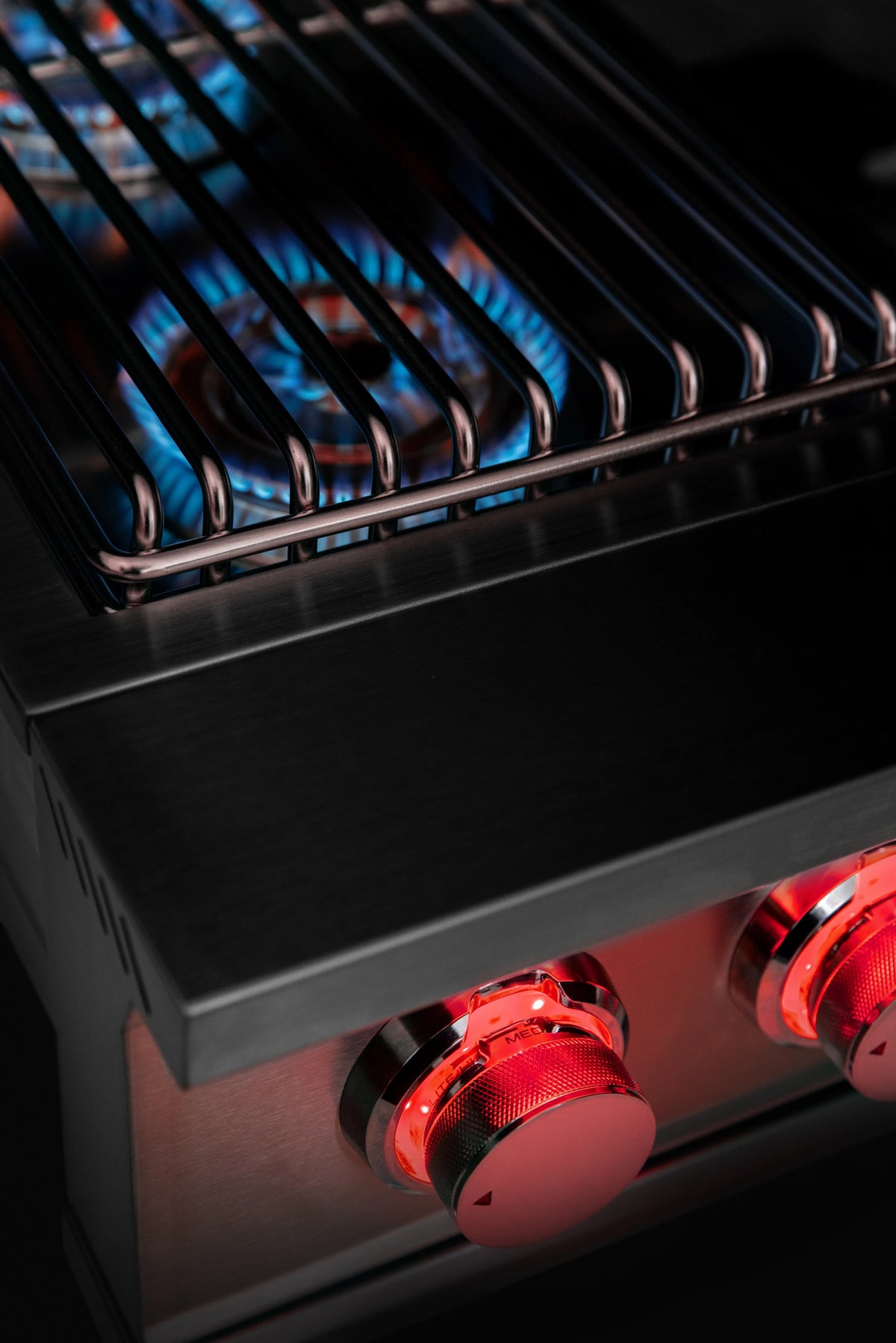 Stainless steel double natural gas side burner grate with glowing blue flames