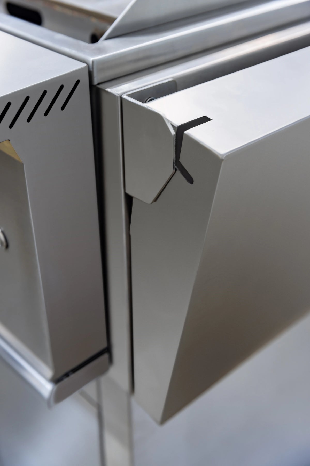 Close-up of stainless side shelf and folding support bracket