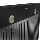 Close-up of black range hood front with circular light openings and vent slots