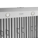 Stainless steel range hood front panel with circular knobs and vertical baffle filters