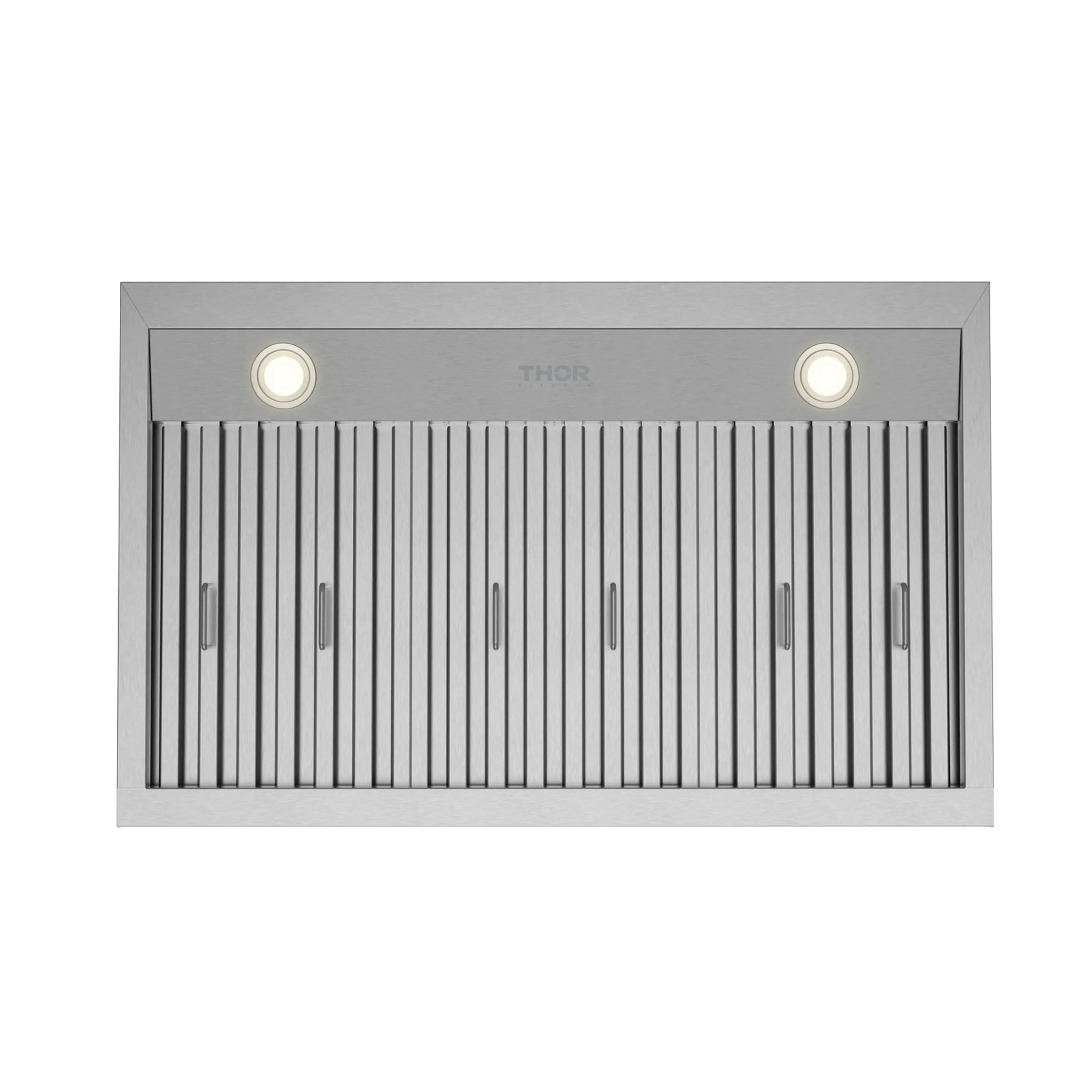 Under-mount range hood underside with lit LED bulbs and vertical baffle filters