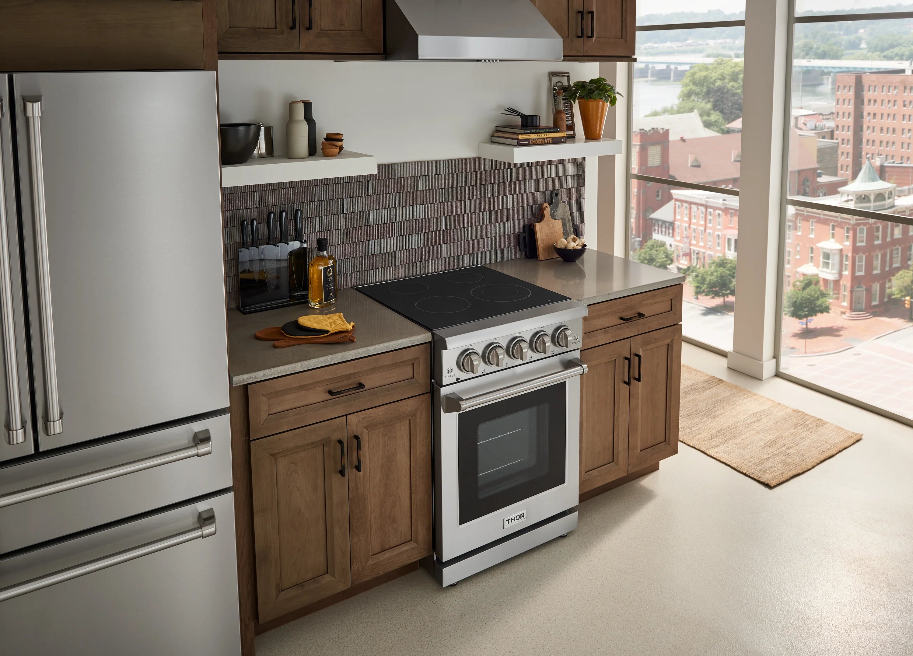 24-inch electric range with stainless steel body and black glass cooktop, oven door