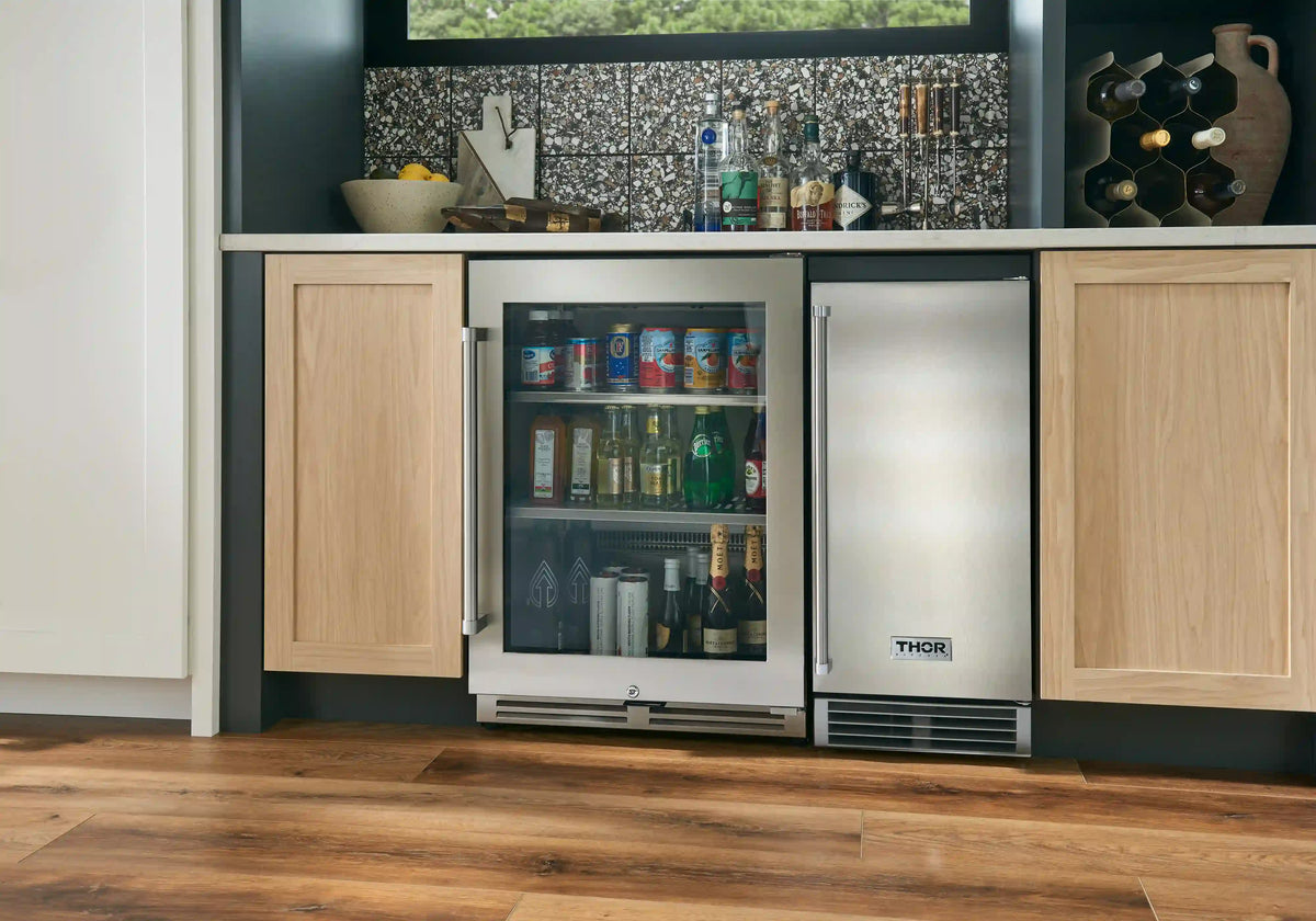 Built-in beverage cooler with glass door installed between kitchen cabinets