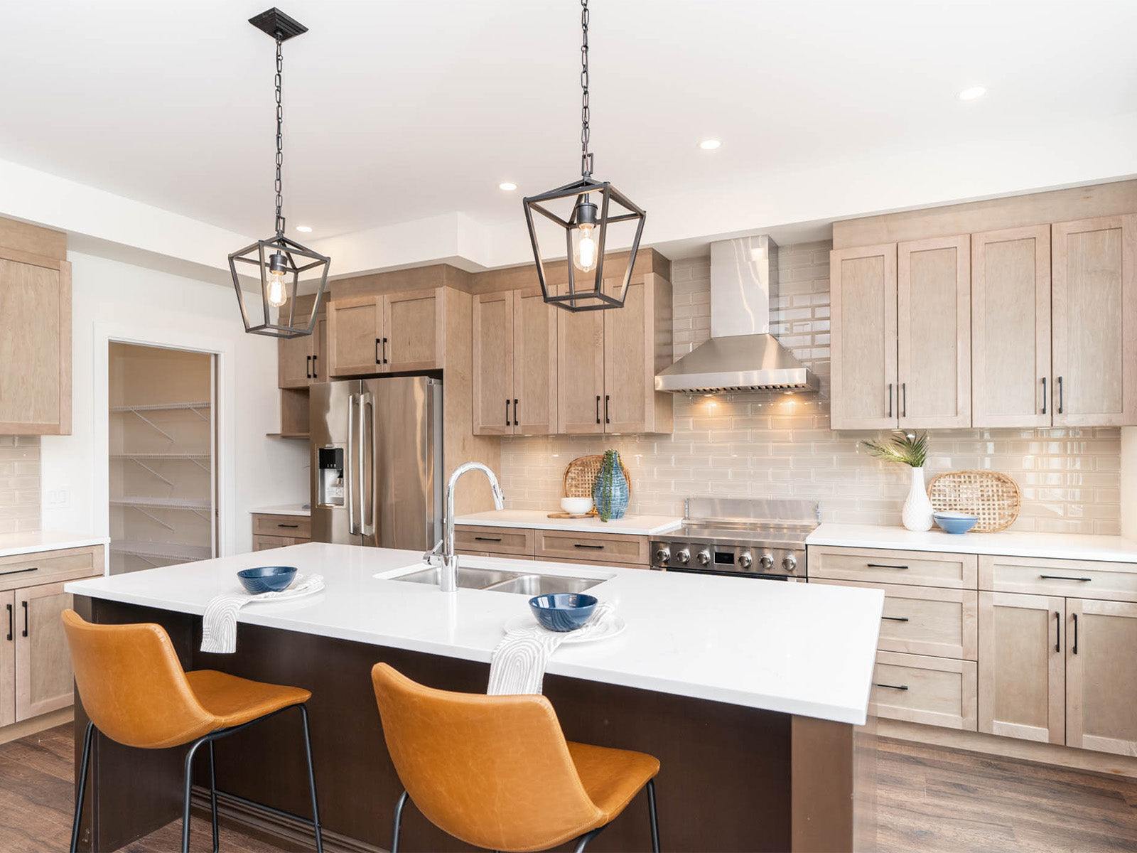 Stainless steel wall-mount range hood with chimney body above the cooktop
