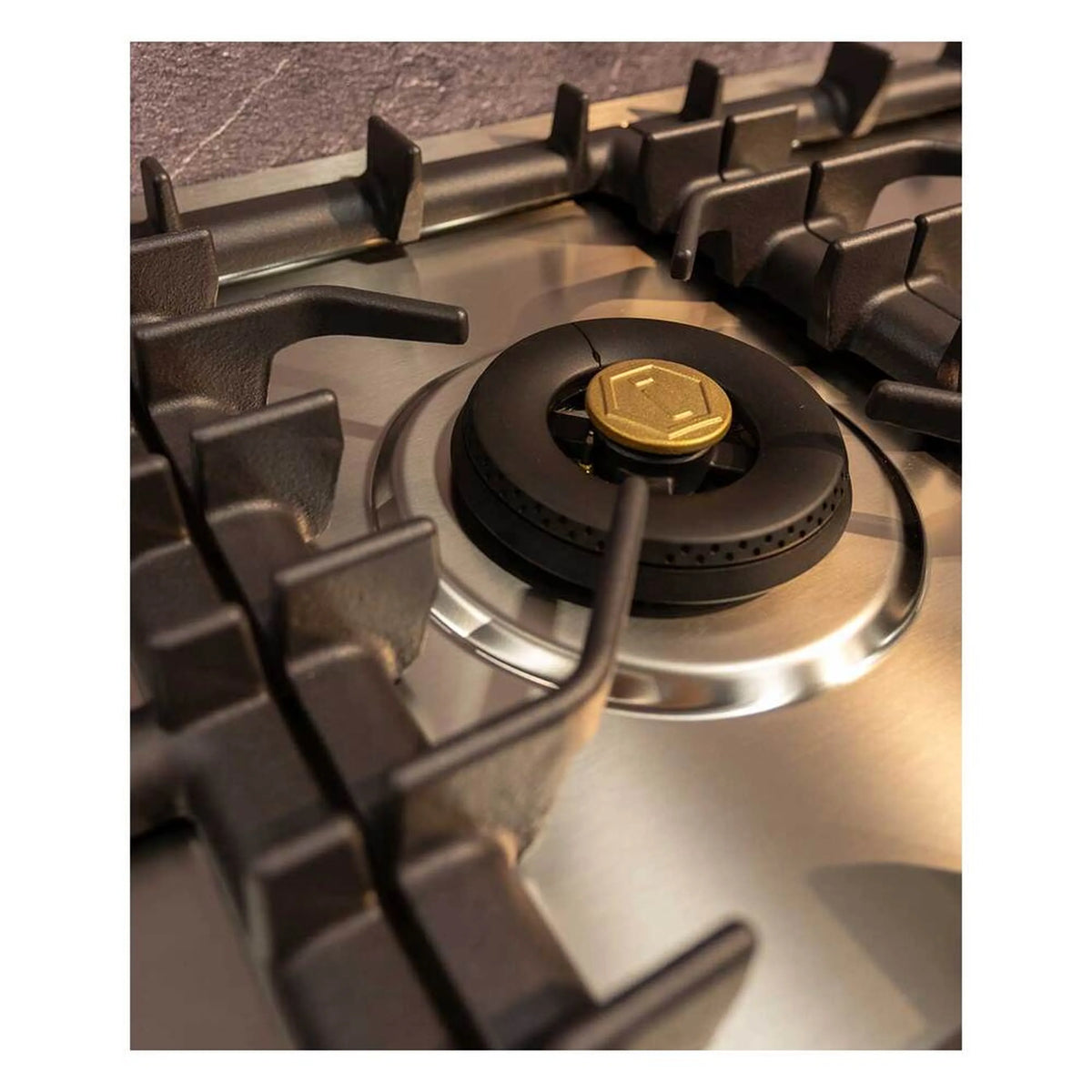 Single brass-capped burner on stainless propane cooktop with black grate supports.