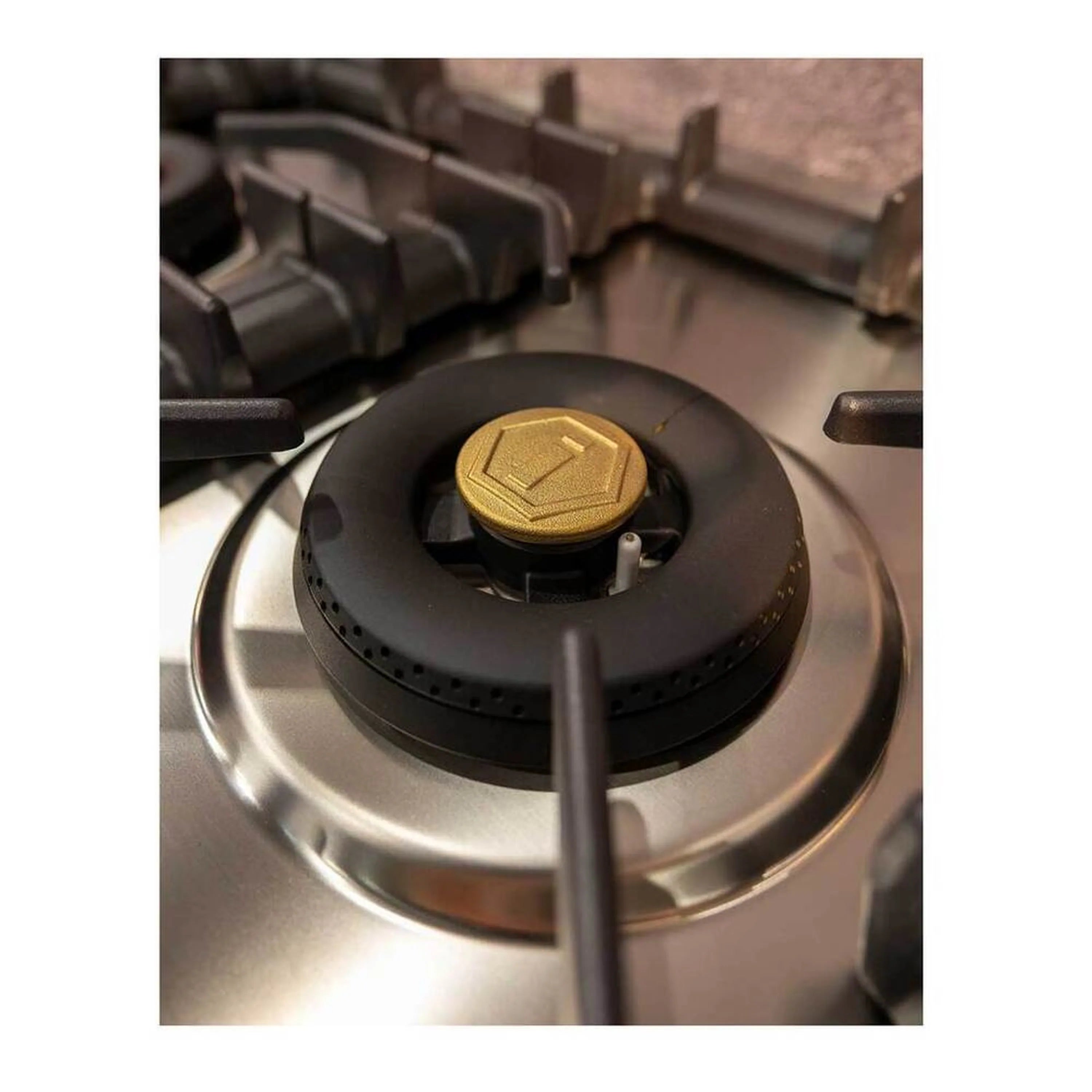 Stainless steel gas cooktop center burner with black cap and metal burner ring