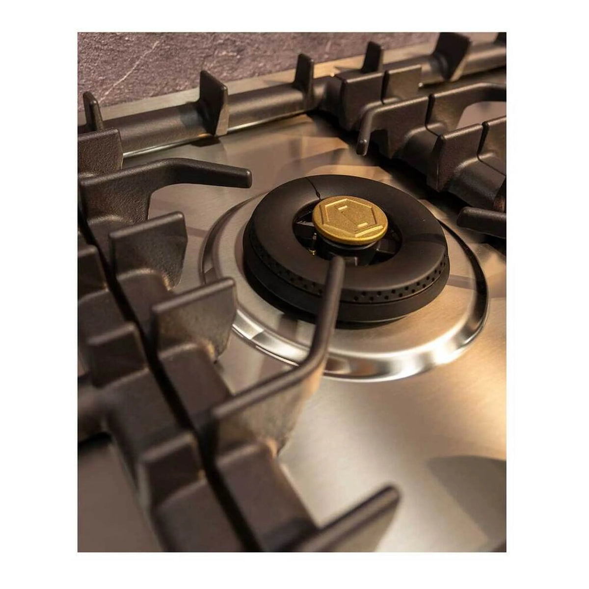 Stainless steel gas burner with black round cap and star-shaped gas vent center