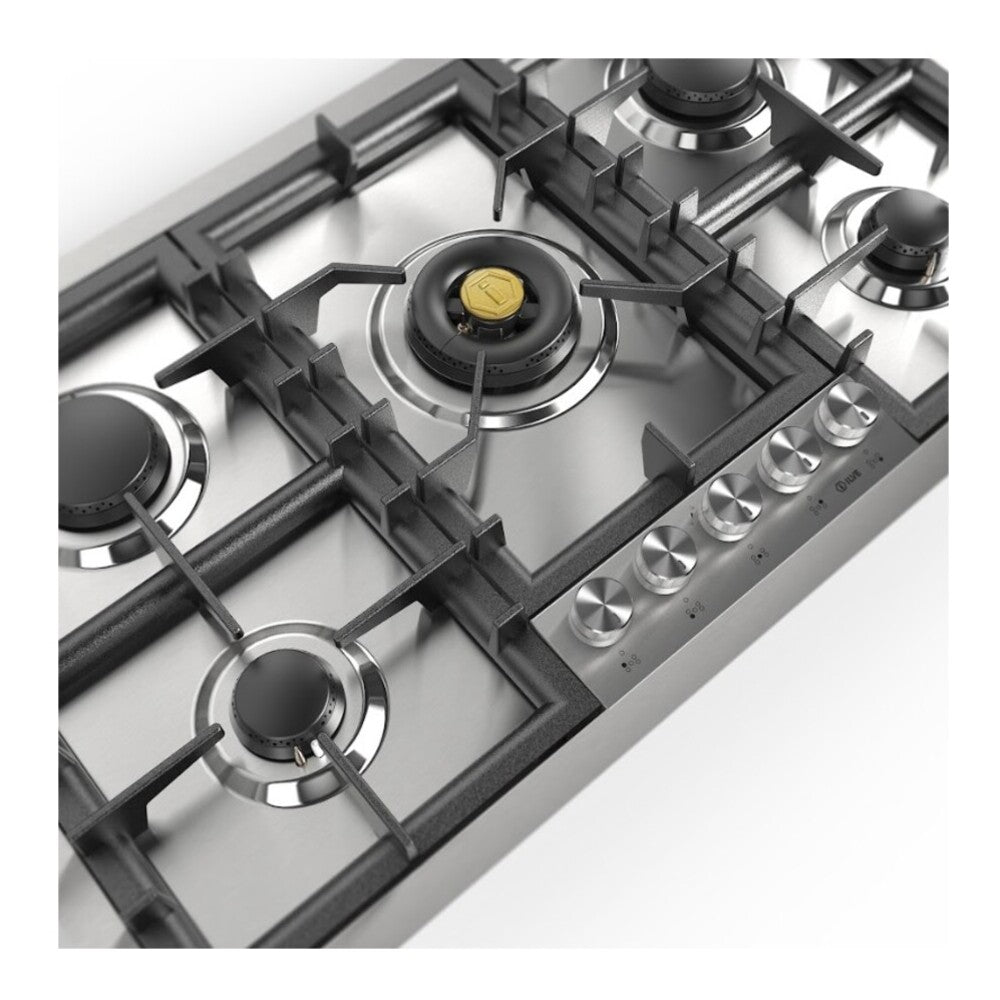 Metal burner head and black grate on a stainless steel gas cooktop near control knobs