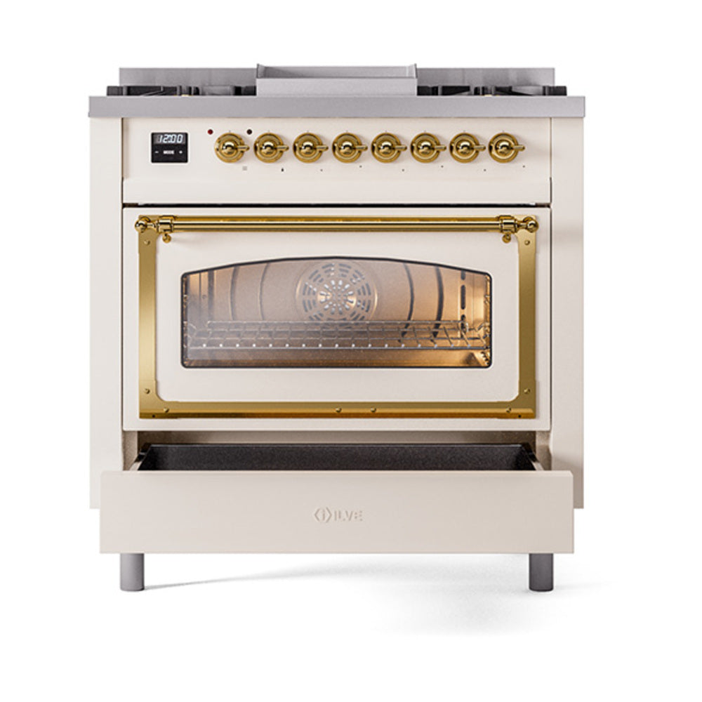 Dual fuel range with closed oven window, brass trim, and gold control knobs