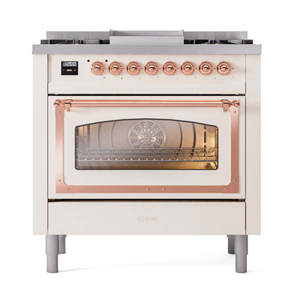 Antique white dual-fuel range with oven window view, copper trim, and burner grates