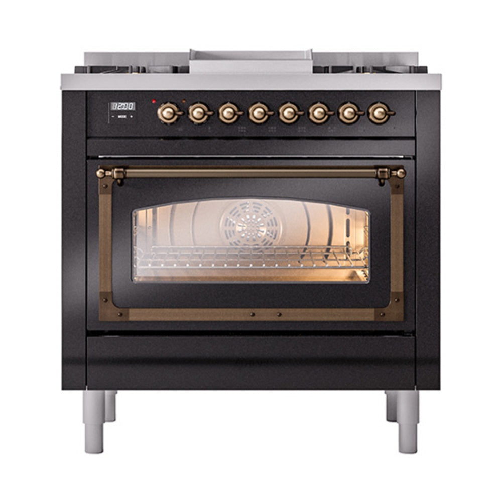 Glossy black dual-fuel range with lit oven glass window and bronze control knobs