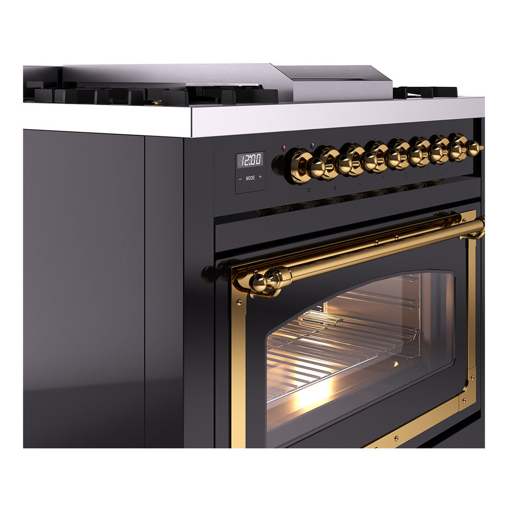 Black dual fuel range with brass control knobs and angled oven glass door