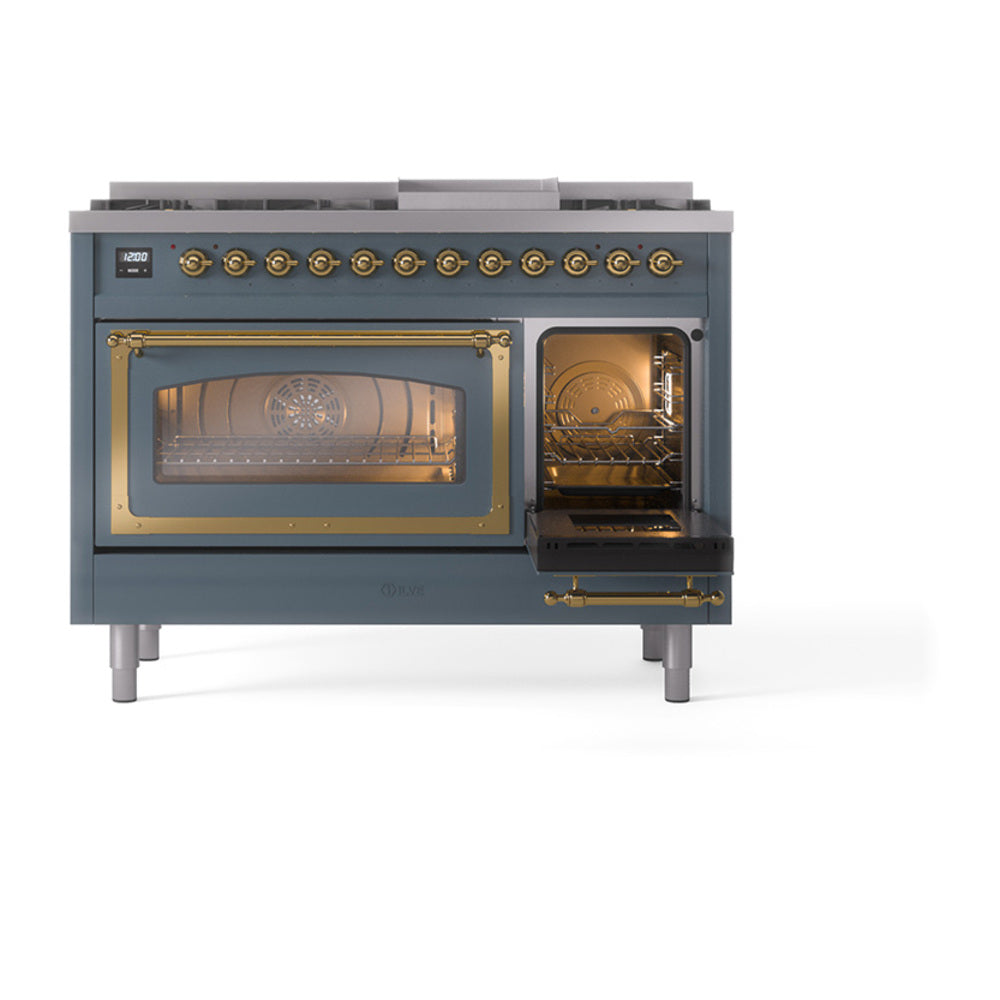 Blue grey freestanding range with brass door frames; left oven open and right oven glass door.