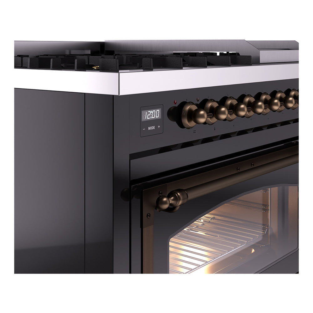 Black dual fuel range with bronze control knobs and an oven door with warm interior