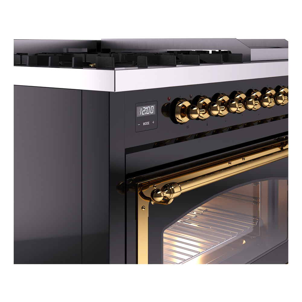 Glossy black dual fuel range control panel with brass knobs and oven door window