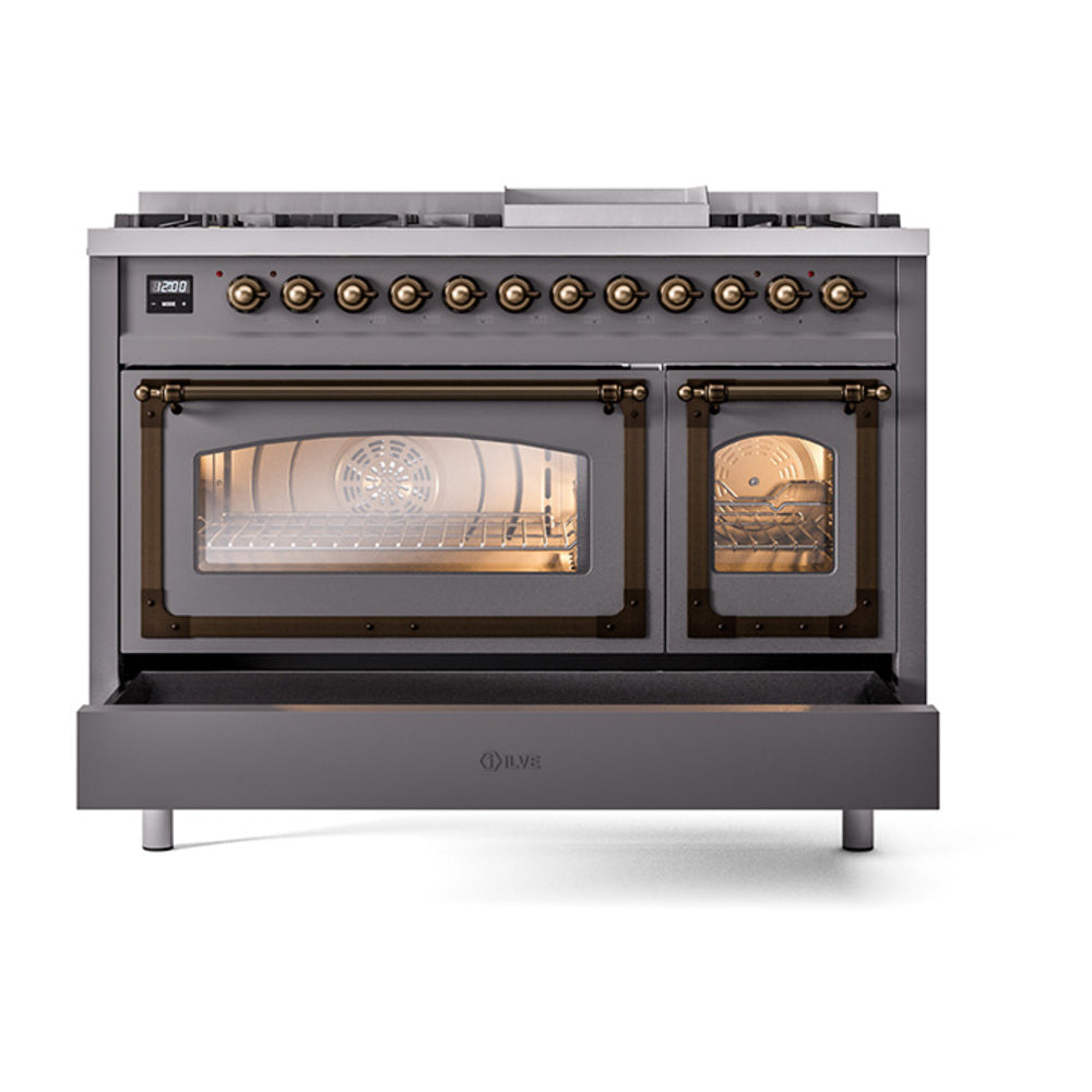 Matte graphite dual fuel range front with bronze-trim control panel and lit oven windows