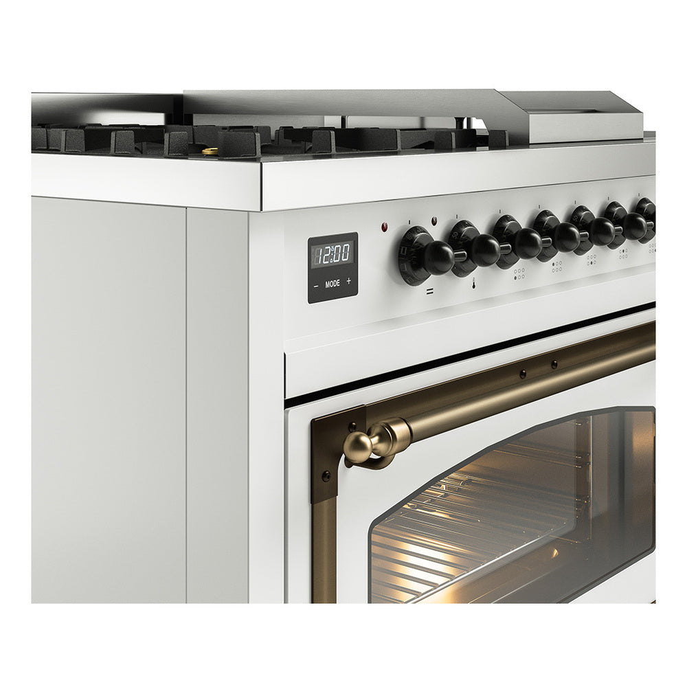 Dual fuel range close-up of brass oven handle and control panel with knobs and display.