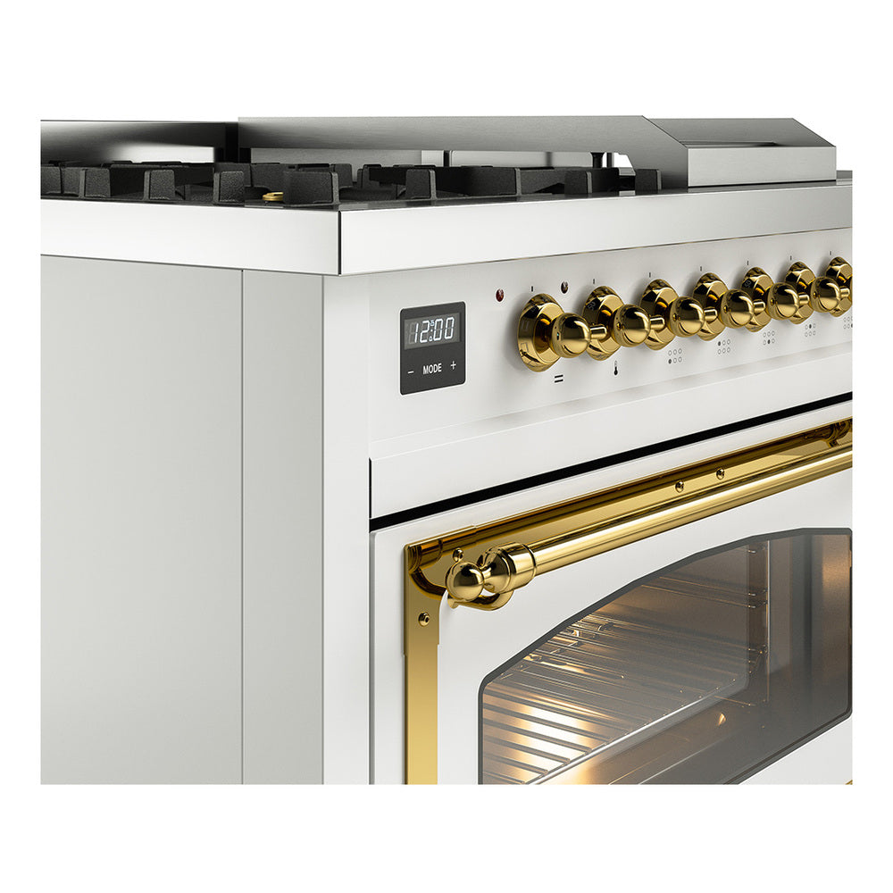 White dual fuel range control area with brass knobs and arched oven handle