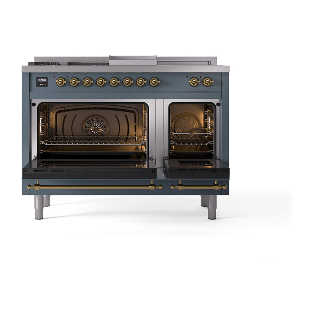 Dual oven doors open on blue grey range with brass accents and interior racks