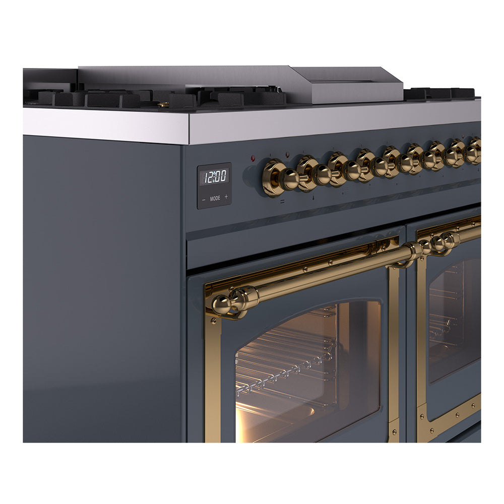 Blue grey range close-up of brass knobs and lit oven window on the control panel