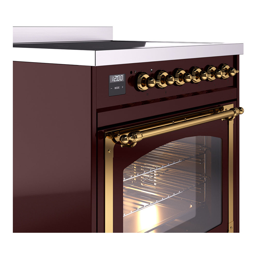 Burgundy induction range showing brass control knobs and oven door handle with glass