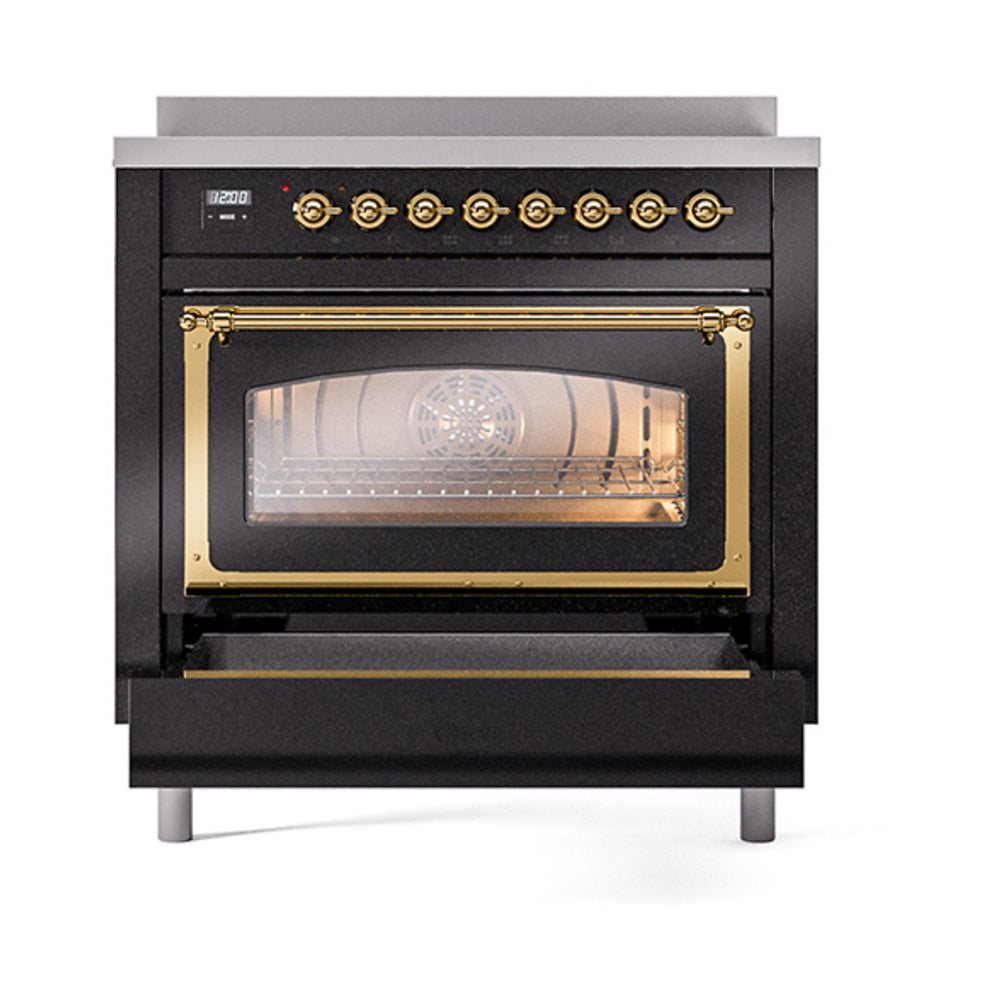 Black induction range with oven door open and brass trim, empty interior
