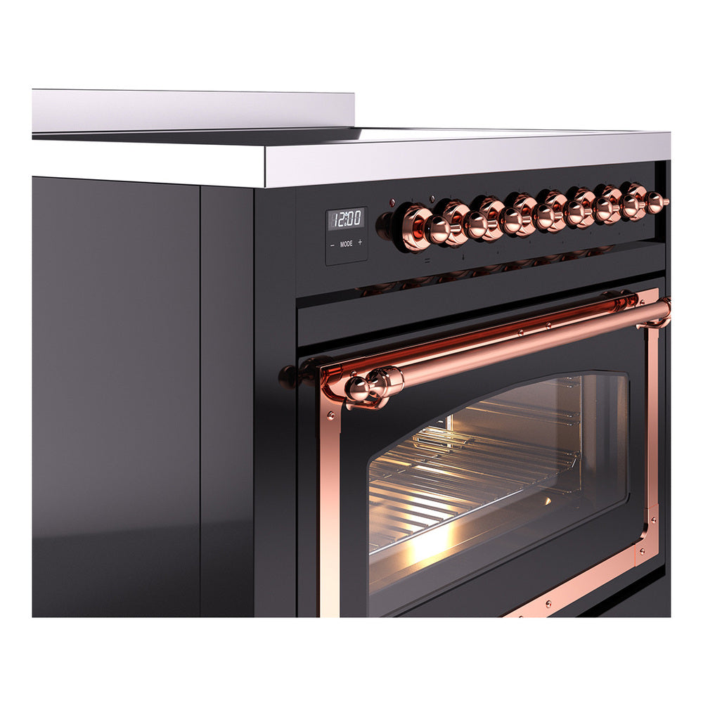 Side view of glossy black induction range with copper knobs and lit glass oven door