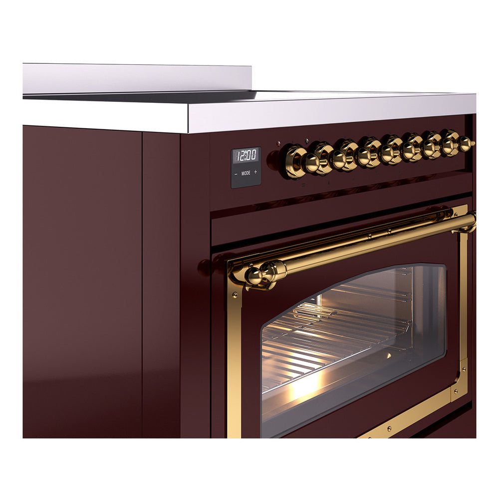Burgundy range with brass oven handle and lit oven window, angled side view