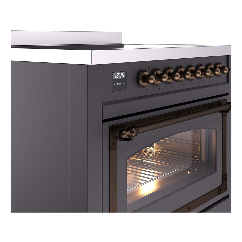 Matte graphite induction range with bronze control knobs and oven door window