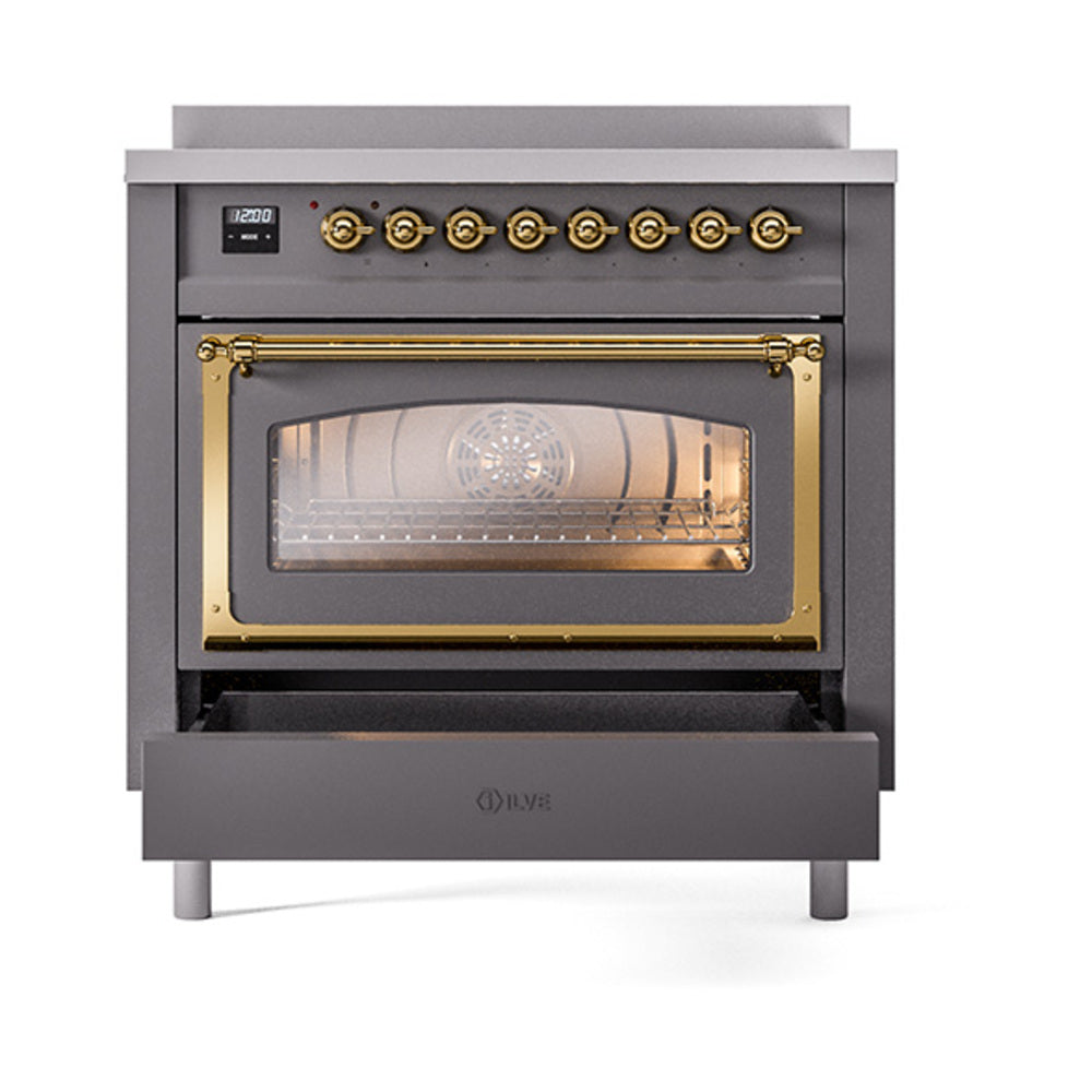 Matte graphite oven with brass-framed window and open lower drawer