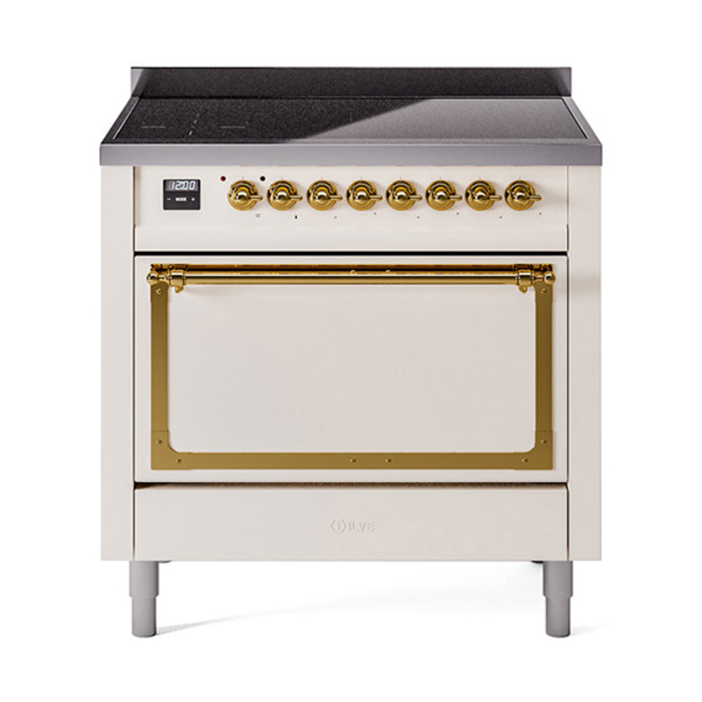 Antique white induction range with brass-trimmed oven door and black glass cooktop