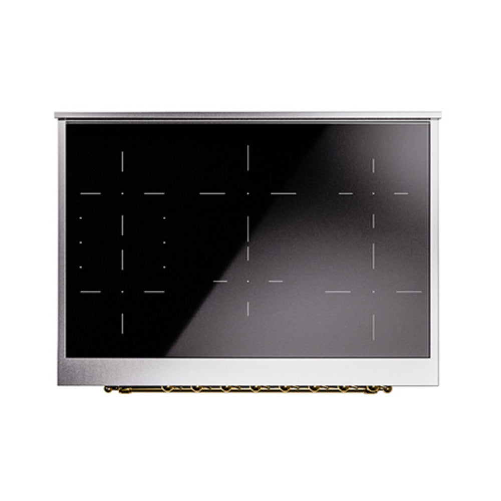 Induction range control panel with dark glass and circular brass-accent knobs