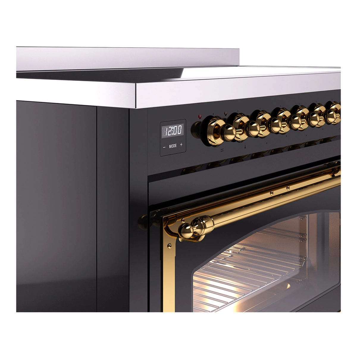 Induction range close-up of brass control knobs and oven door handle