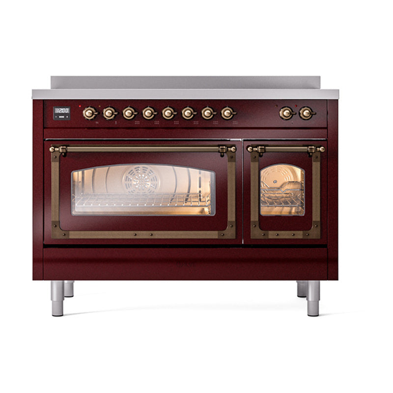 Burgundy induction range with bronze knobs and lit oven interiors behind glass