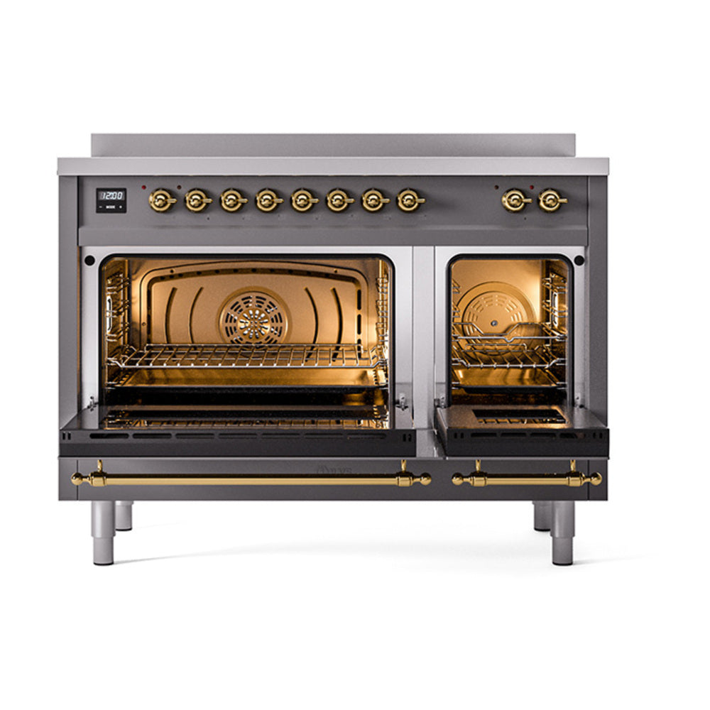 Graphite induction range with open dual ovens, brass handles, and oven racks visible
