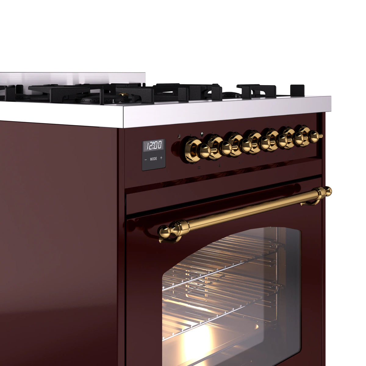 Burgundy dual-fuel range corner close-up with brass control knobs and oven window