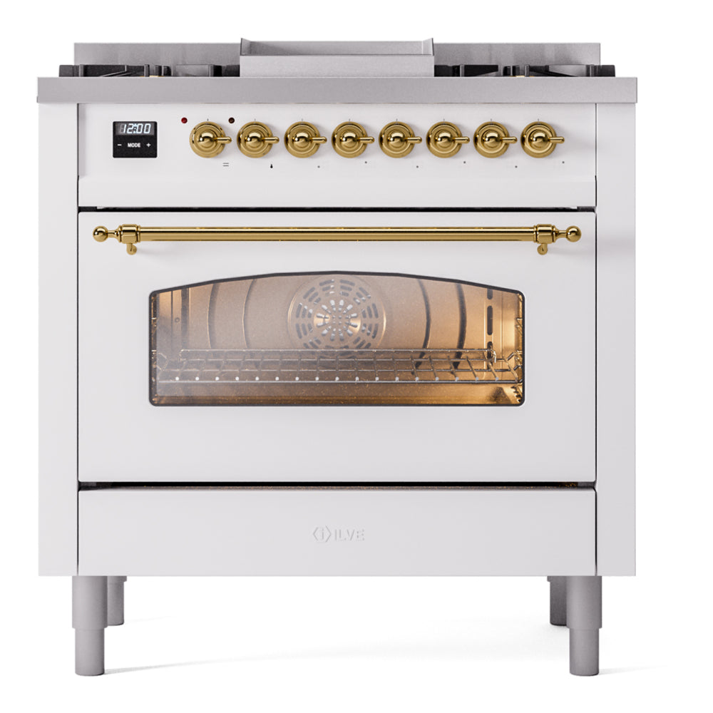 Freestanding dual-fuel range front with glass oven door, brass handle rail, gold knobs