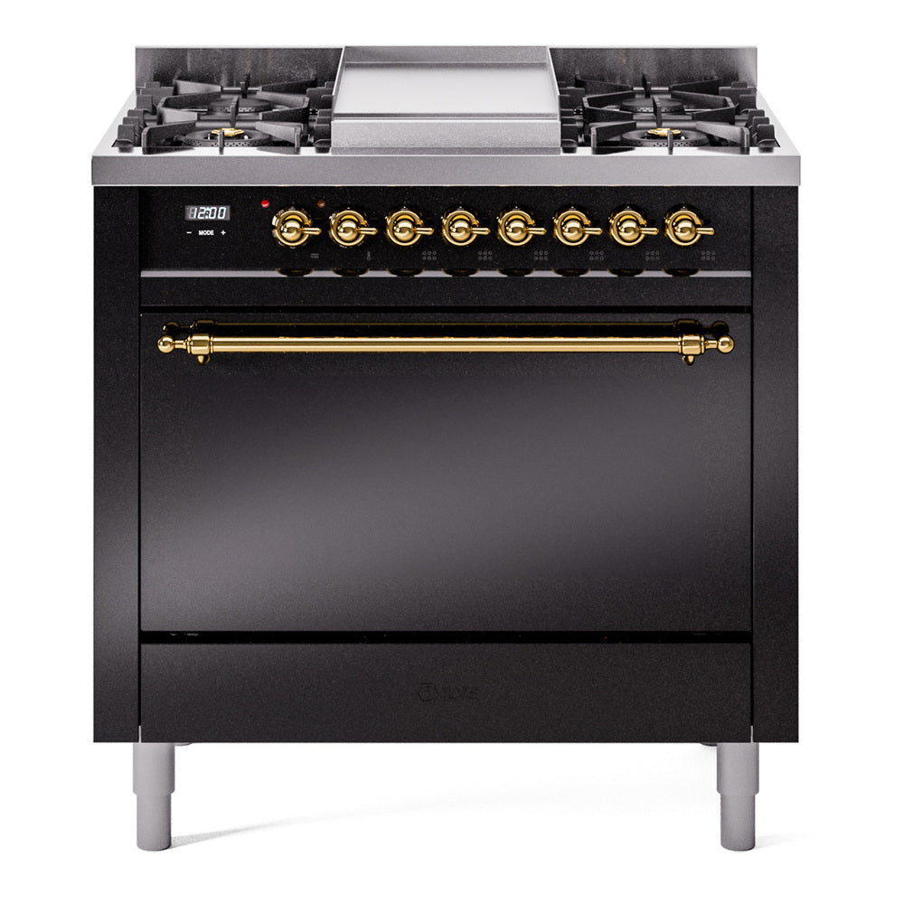 Glossy black dual fuel range with brass-trimmed control knobs and open cooktop