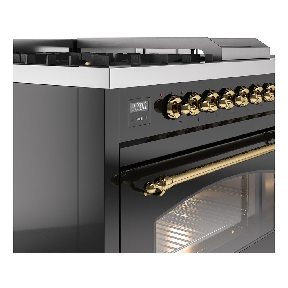 Brass control knobs and handle on glossy black dual fuel range with oven door