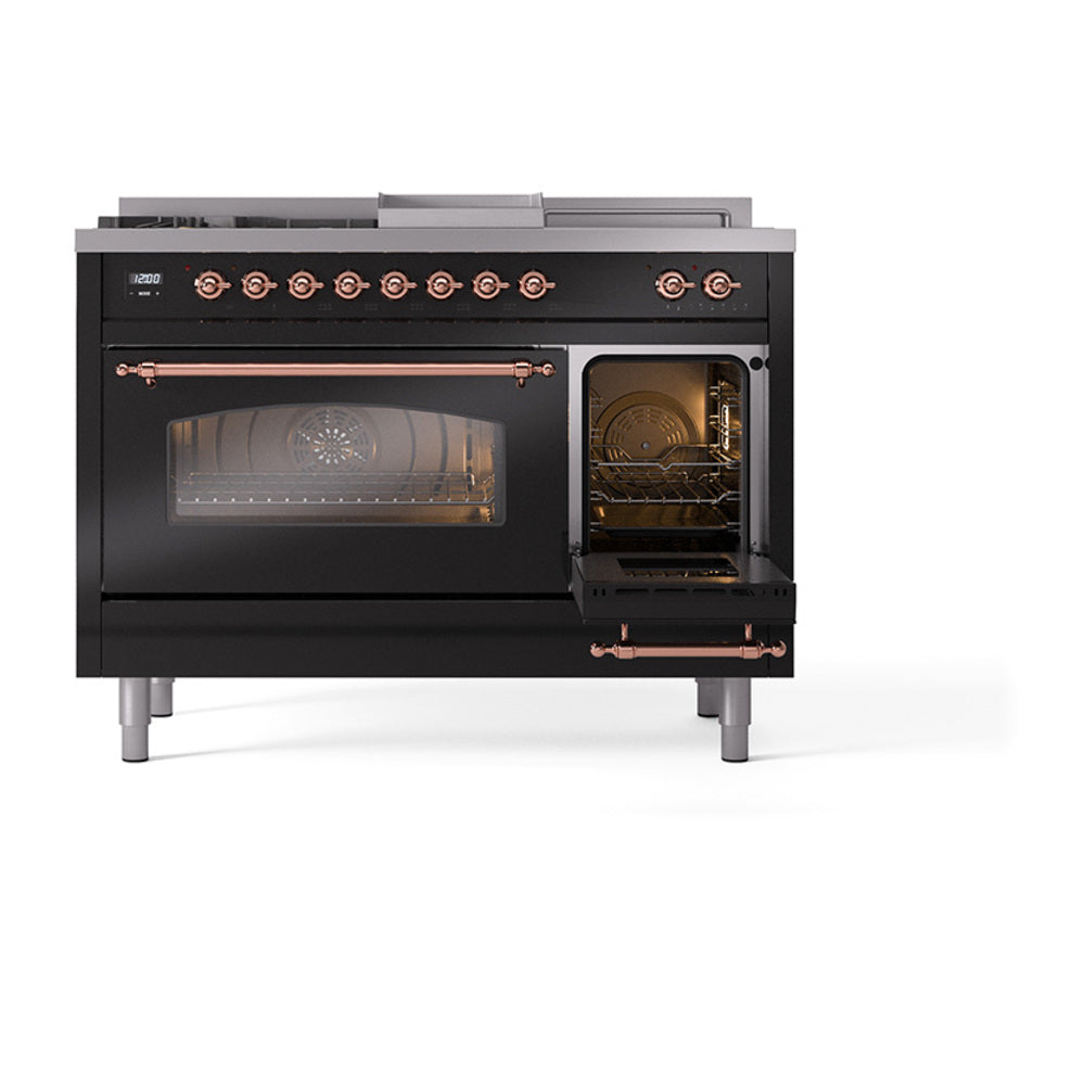 Black range with copper handle trim and lit oven interiors behind glass doors