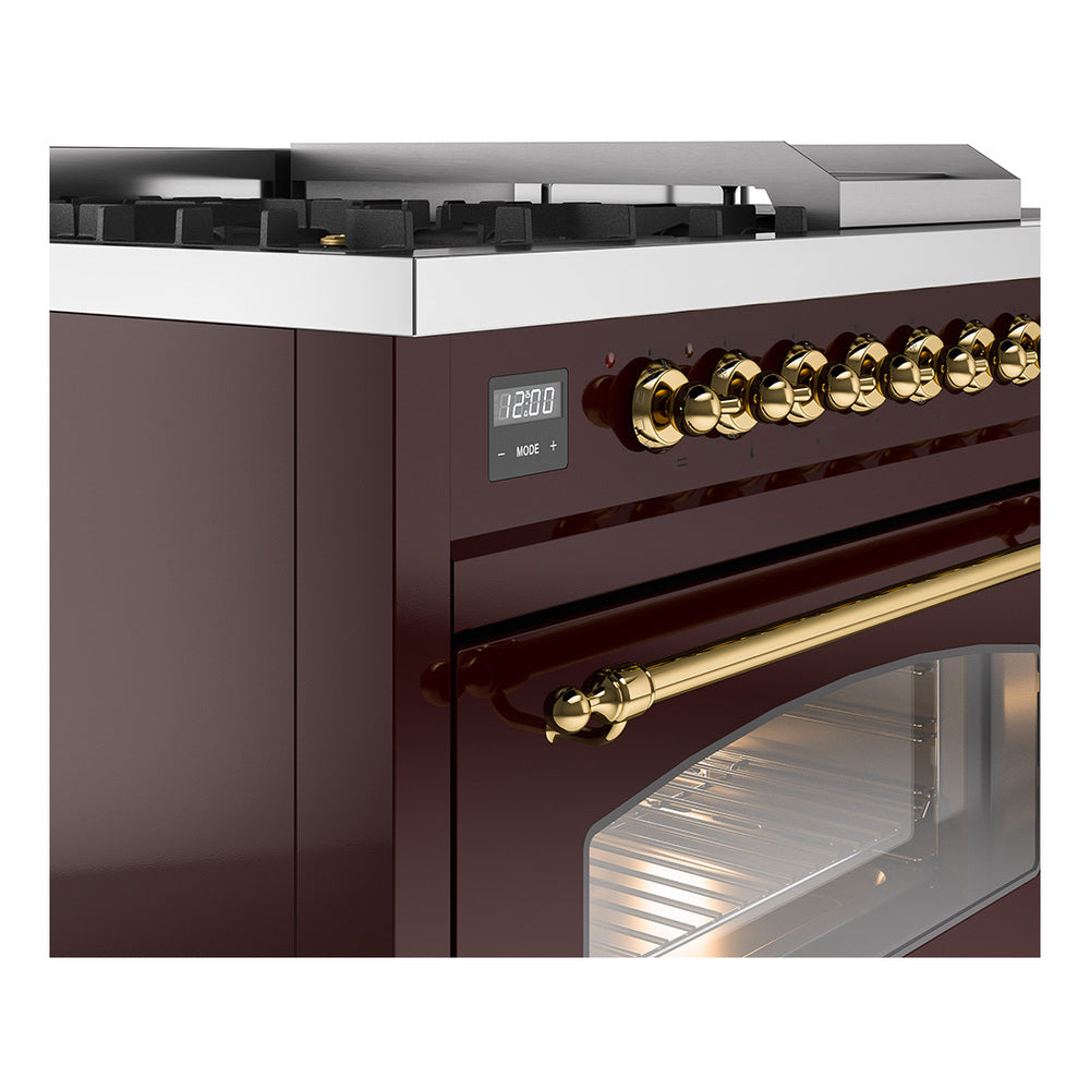 Close-up of burgundy control panel with brass knobs and oven door window