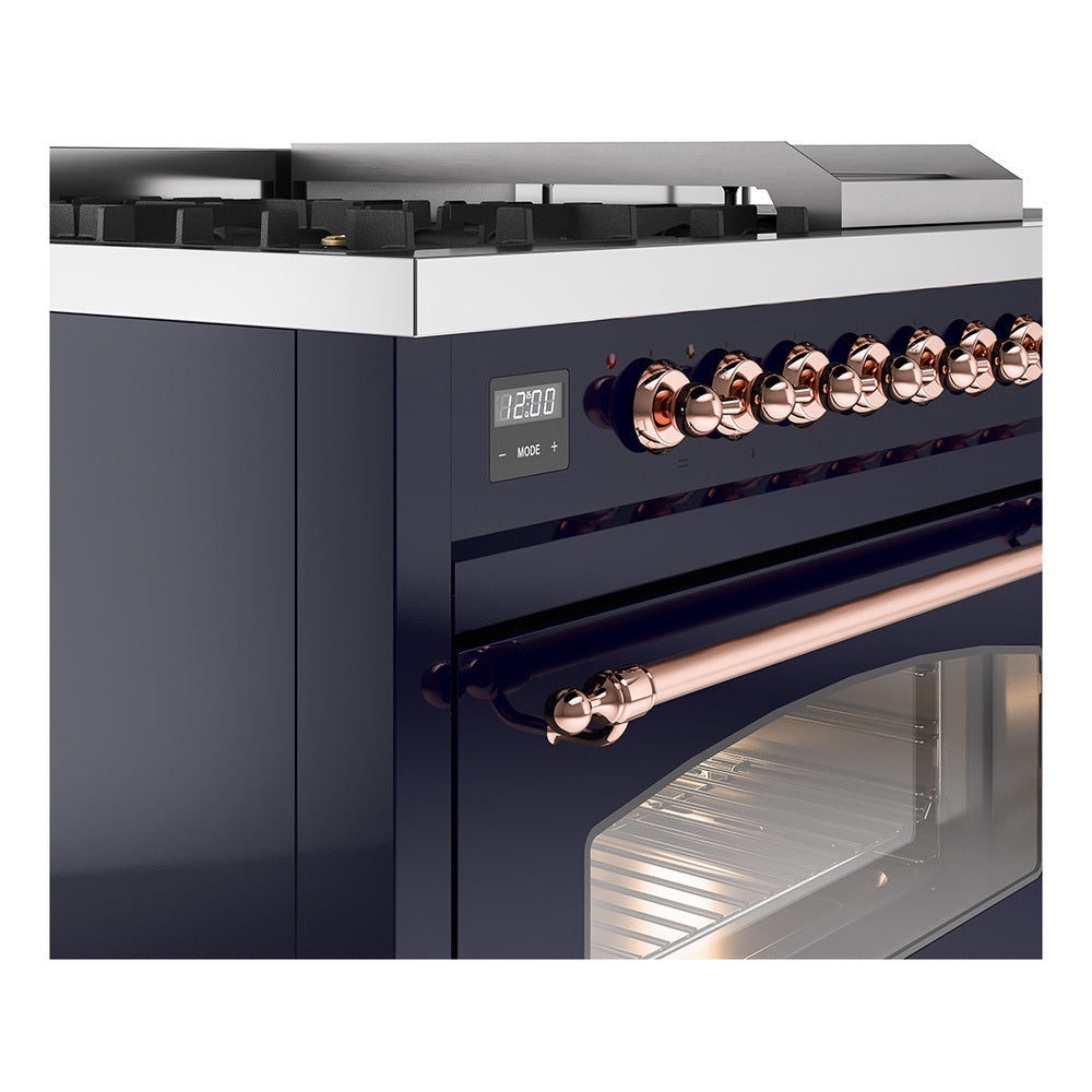 Midnight blue dual fuel range control panel with copper knobs above a glass oven door