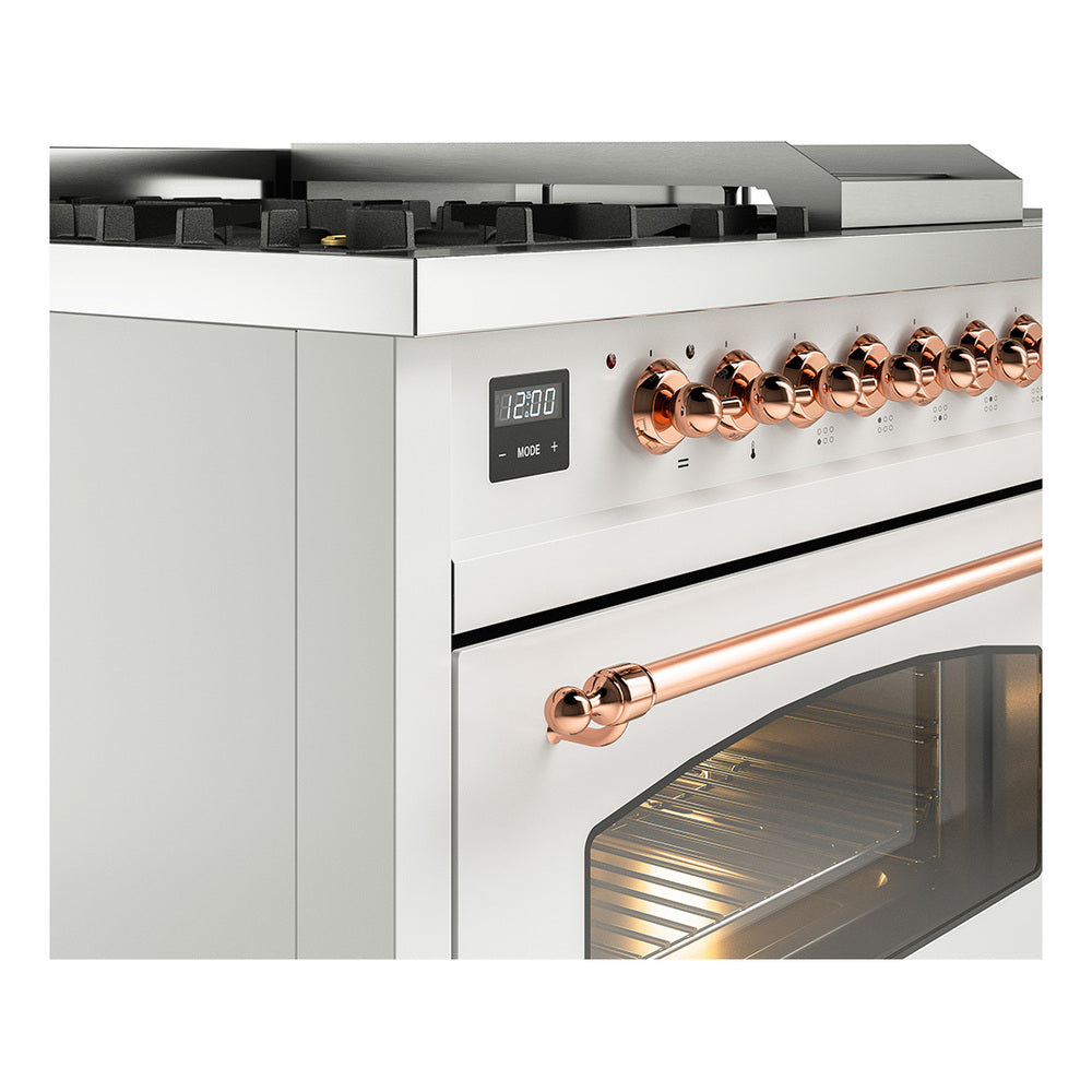 Close view of white dual-fuel range controls with copper knobs and handle.
