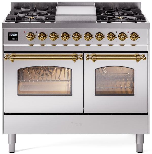 Freestanding dual-fuel range front with brass control knobs, grates, and glass oven doors