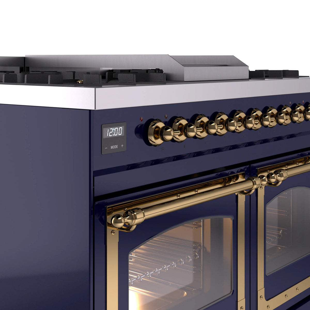 Midnight blue dual fuel range control panel and brass oven handle with lit oven door