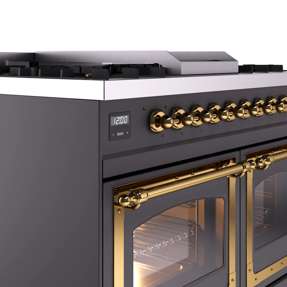 ILVE range control panel with brass knobs and matte graphite trim beside glass oven doors