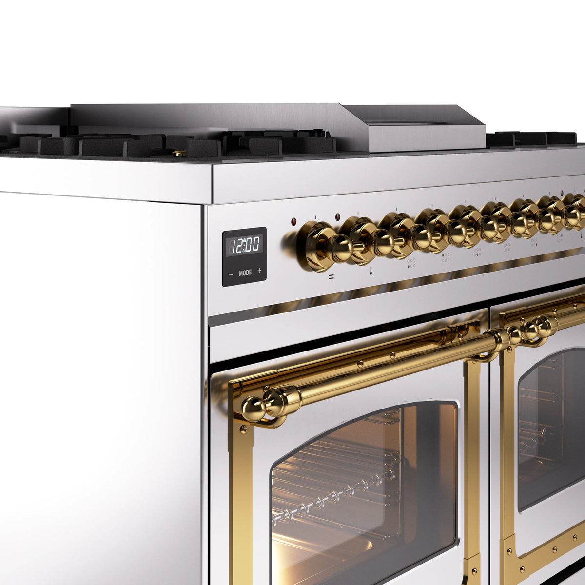 Brass-trimmed control knobs and stainless steel range front with open oven doors