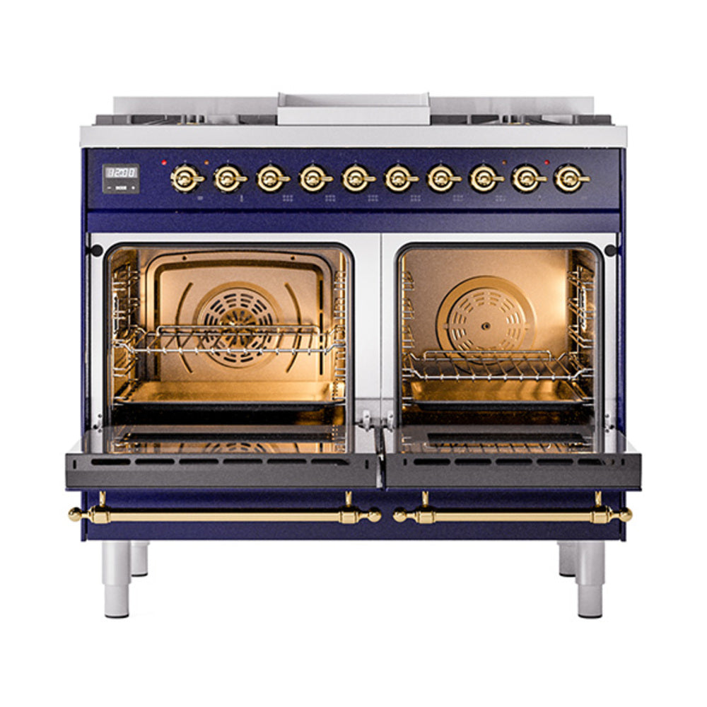 Open dual ovens on a midnight blue gas range with brass trim and racks